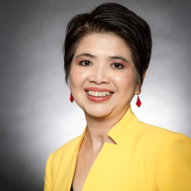 Thanh Nguyen headshot with bright yellow blazer