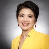 Thanh Nguyen headshot with bright yellow blazer